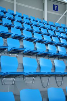 empty cyan seats in sport hall, stadium, sector f