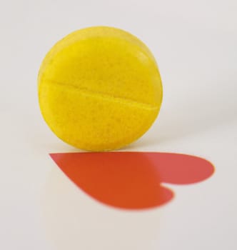 Yellow tablet and heart on the playing card background