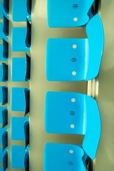 empty cyan plastic seats, grey concrete, photo taken in empty stadium