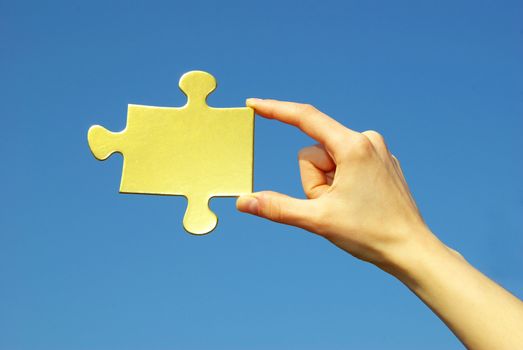  puzzle in hand isolated on blue background