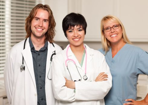 Three Smiling Male and Female Doctors or Nurses in the Office.