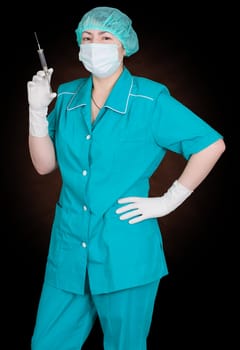 Portrait of nurse with syringe in gloved hand