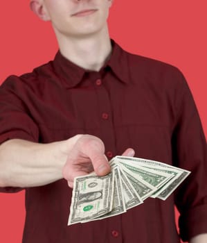 Man with pack of dollars on his hand