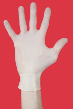 Bristling fingers on medical glove on red background