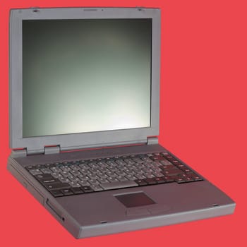 The grey laptop on the red background