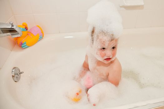 Bubbles on top of the water, less ambiguously known as a foam bath can be obtained by adding a product containing foaming surfactants to water and temporarily aerating it by agitation