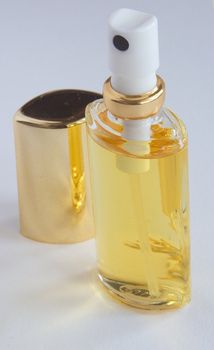 a bottle of perfum spray open with the lid at the side