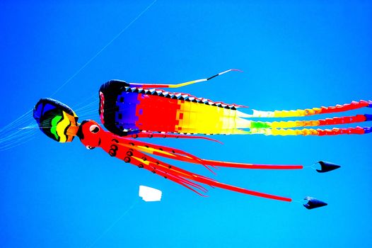 Colorful kites flying in blue sky, Sanur, Bali, Indonesia.