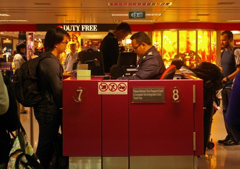 Passport control at Singapore International airport. This airport handles 37 million passengers annually and is Southeast Asia's largest airport. Airport security worldwide has become more stringent in recent years due to an increase in terrorist attacks at airports and on air planes. Singapore,  April 29 2009.