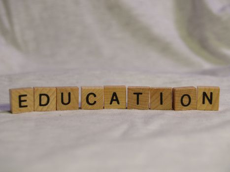 The word EDUCATION spelled out with wooden tiles