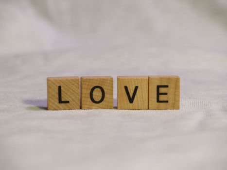 The word LOVE spelled out with wooden tiles