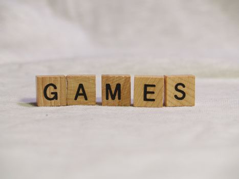The word GAMES spelled out with wooden tiles    
