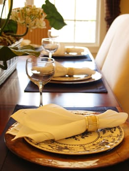 Closeup of three place settings with a bright window in the background