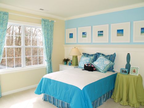 A very nicely decorated bright blue child's bedroom 