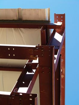 Looking up at the corner of a metal framed commercial building under construction. 