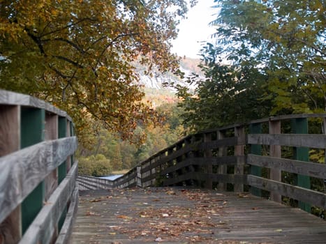 View along a mountain boardwalk next to a lake in the autumn