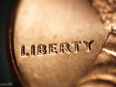 Macro of a penny focused on the word "LIBERTY"