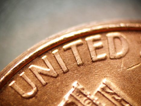 Macro of a penny focusing on the word "UNITED"