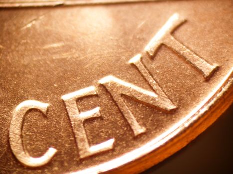 Macro of a penny focused on the word "CENT"