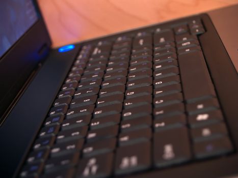 Side angle view of a laptop computer keyboard with a shallow depth of field