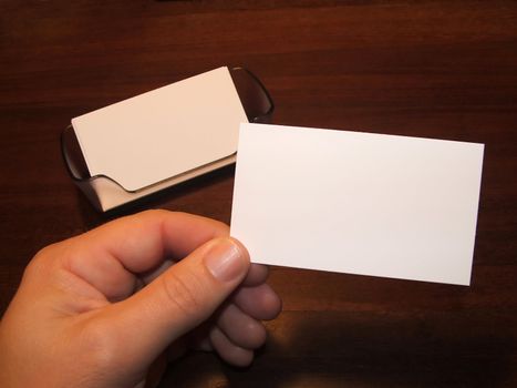 Male hand holding a blank business card