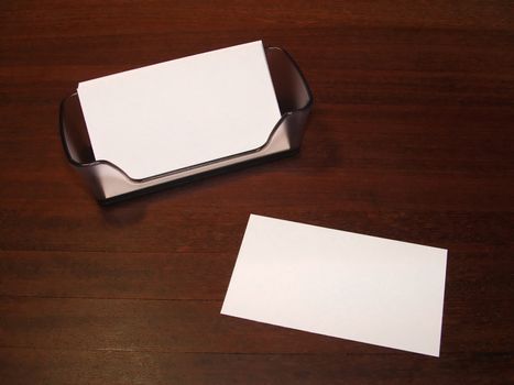 Blank business card on desk with holder