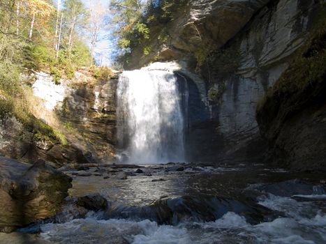 View of a majestic waterfall from downstream