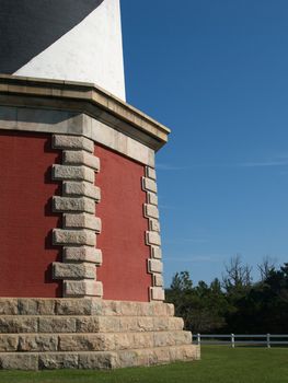 Base of lighthouse with green grass