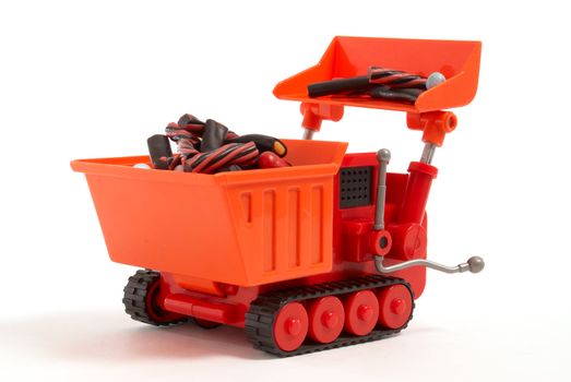 Toy digger loading liquorice candy