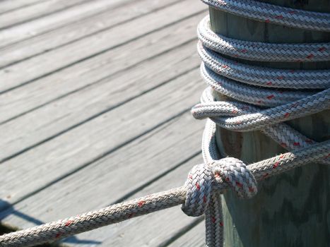 Thick rope tied around a dock piling