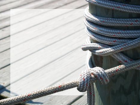 Thick rope tied around a dock piling