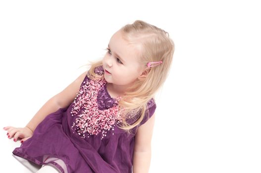 Studio shot of baby girl in lilac gala dress