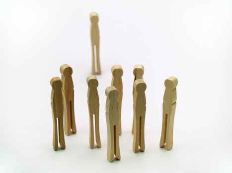 Group of clothespins standing together, one off to itself