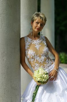 The beautiful bride with a bouquet from roses