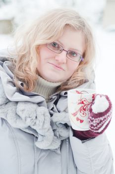 Shot of beautiful blond woman wuth cup on hands