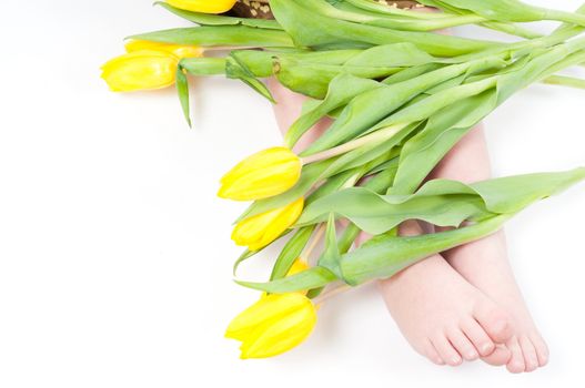 Studio shot of little girl foots with flowers