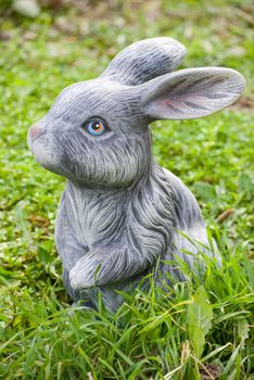 rabbit statue on green grass backgound