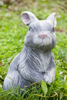 rabbit statue on green grass backgound