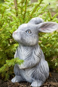 rabbit statue on green pine tree backgound