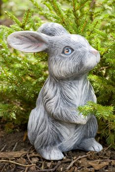 rabbit statue on green pine tree backgound