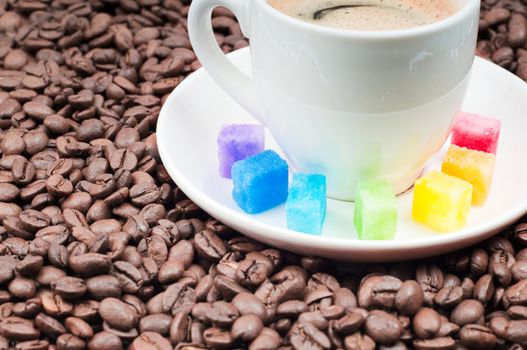 Shot of multicolored slabs of shugar and cup of coffee