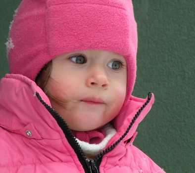 Beautiful children's face in winter with snow                   