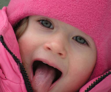 Beautiful children's face in winter with snow                               