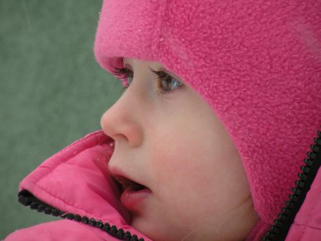 Beautiful children's face in winter with snow                          