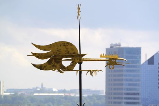 Old golden weathercock on roof in Tallinn