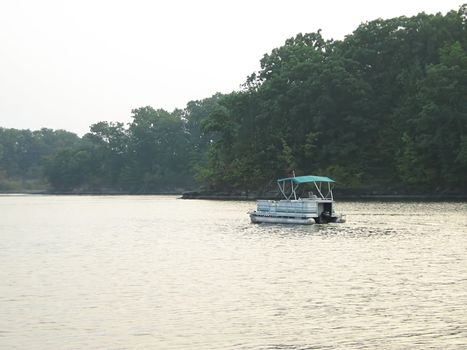 A photograph of a motorized boat on a waterway.
