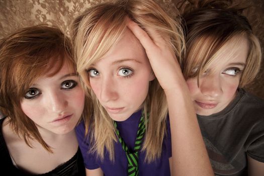 Portrait of three pretty young girls on a gold background