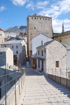 View from the Old Bridge of the east tower in Mostar old town on a sunny day.