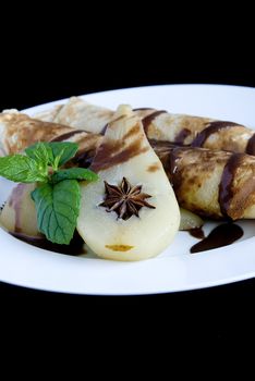 Rolled pancakes with poached pear