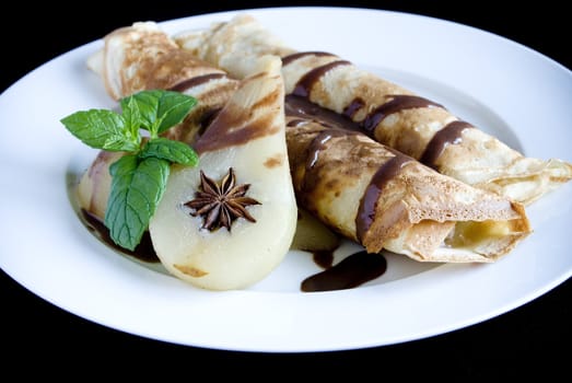 Rolled pancakes with poached pear